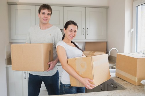 Professional movers handling office equipment during a relocation